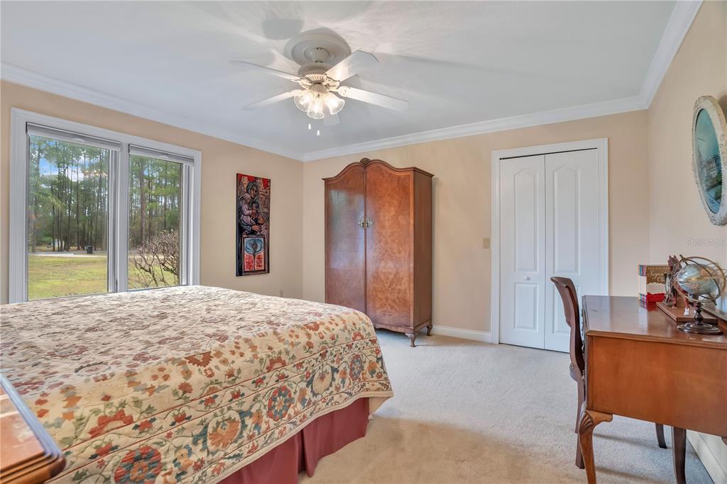 11450 Fangorn Road Orlando, FL 32825 - Photo 39 of 58 a bedroom with a bed and a chandelier