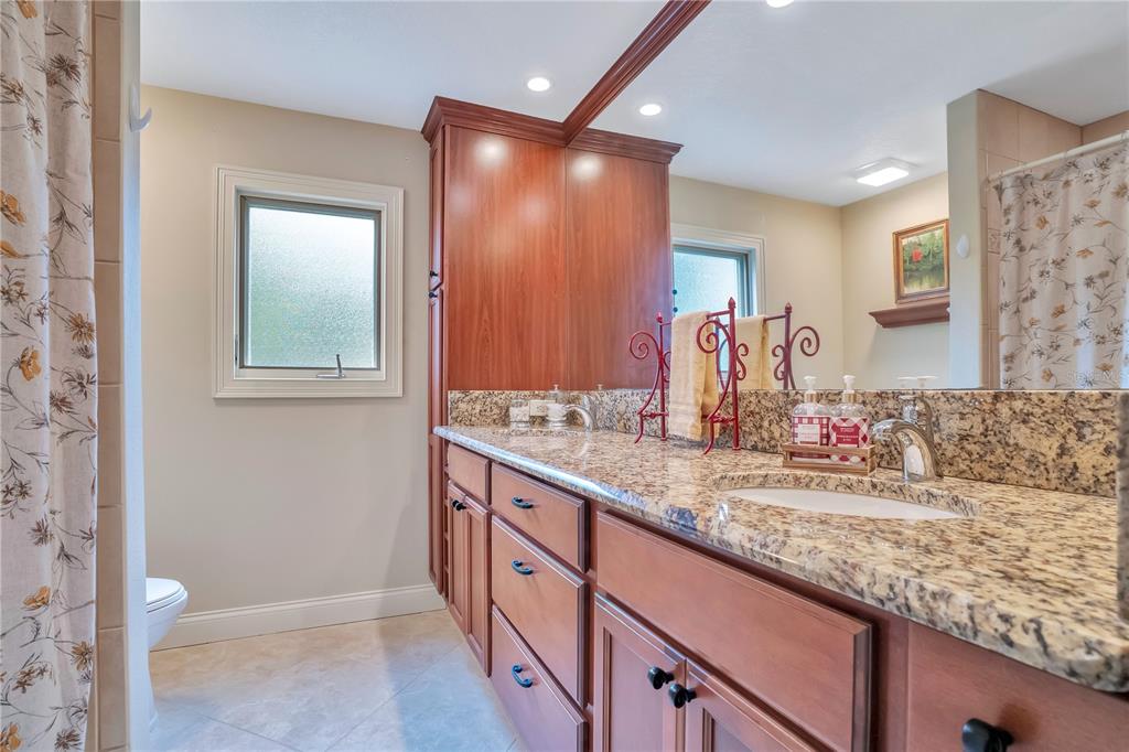 11450 Fangorn Road Orlando, FL 32825 - Photo 40 of 58 a bathroom with a sink and a mirror