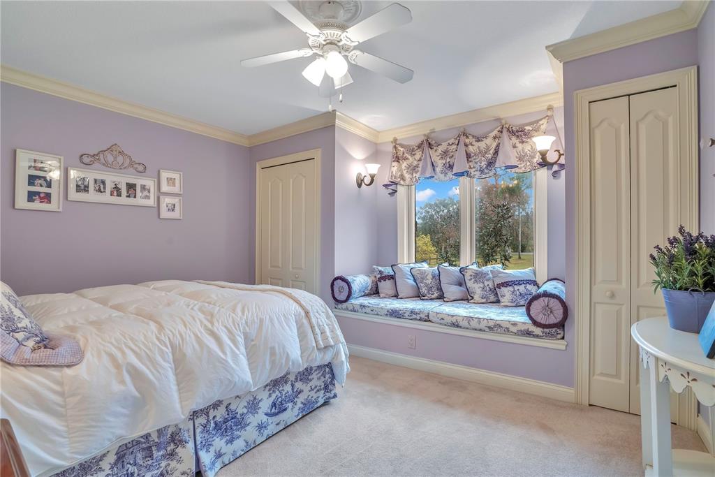 11450 Fangorn Road Orlando, FL 32825 - Photo 42 of 58 a spacious bedroom with a bed and a chandelier