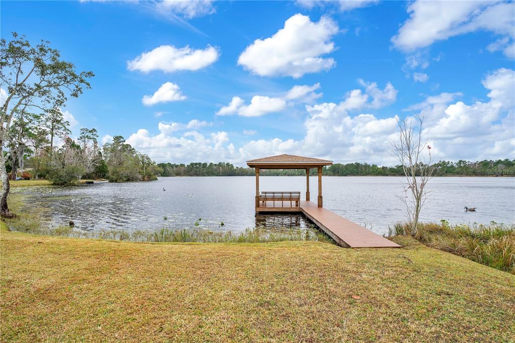 11450 Fangorn Road Orlando, FL 32825 - Photo 57 of 58 a view of a lake with a yard