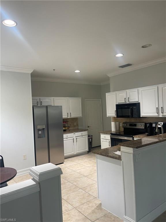 884 Hampton Circle, Unit 159 Naples, FL 34105 - Photo 7 of 28 a kitchen with stainless steel appliances a refrigerator a stove a sink a microwave a counter space and cabinets
