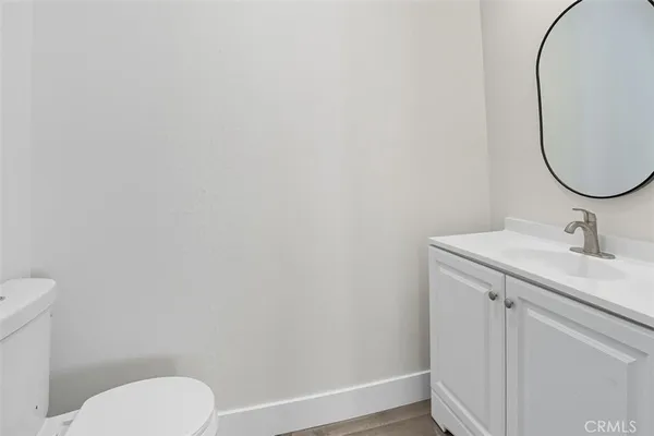 a bathroom with a sink toilet and a mirror