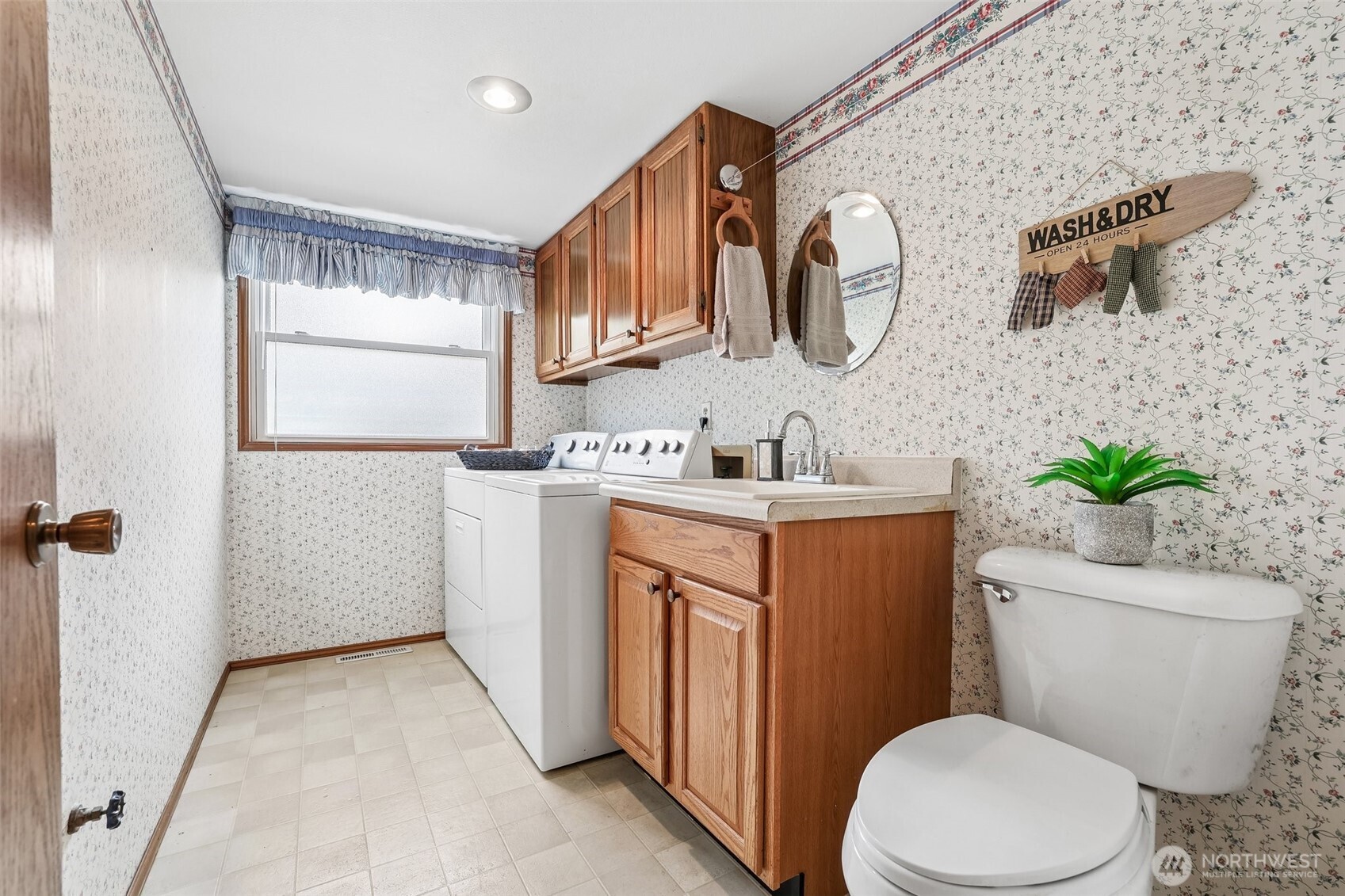 15601 160th Court Southeast Renton, WA 98058 - Photo 14 of 19 a bathroom with a granite countertop toilet sink and mirror