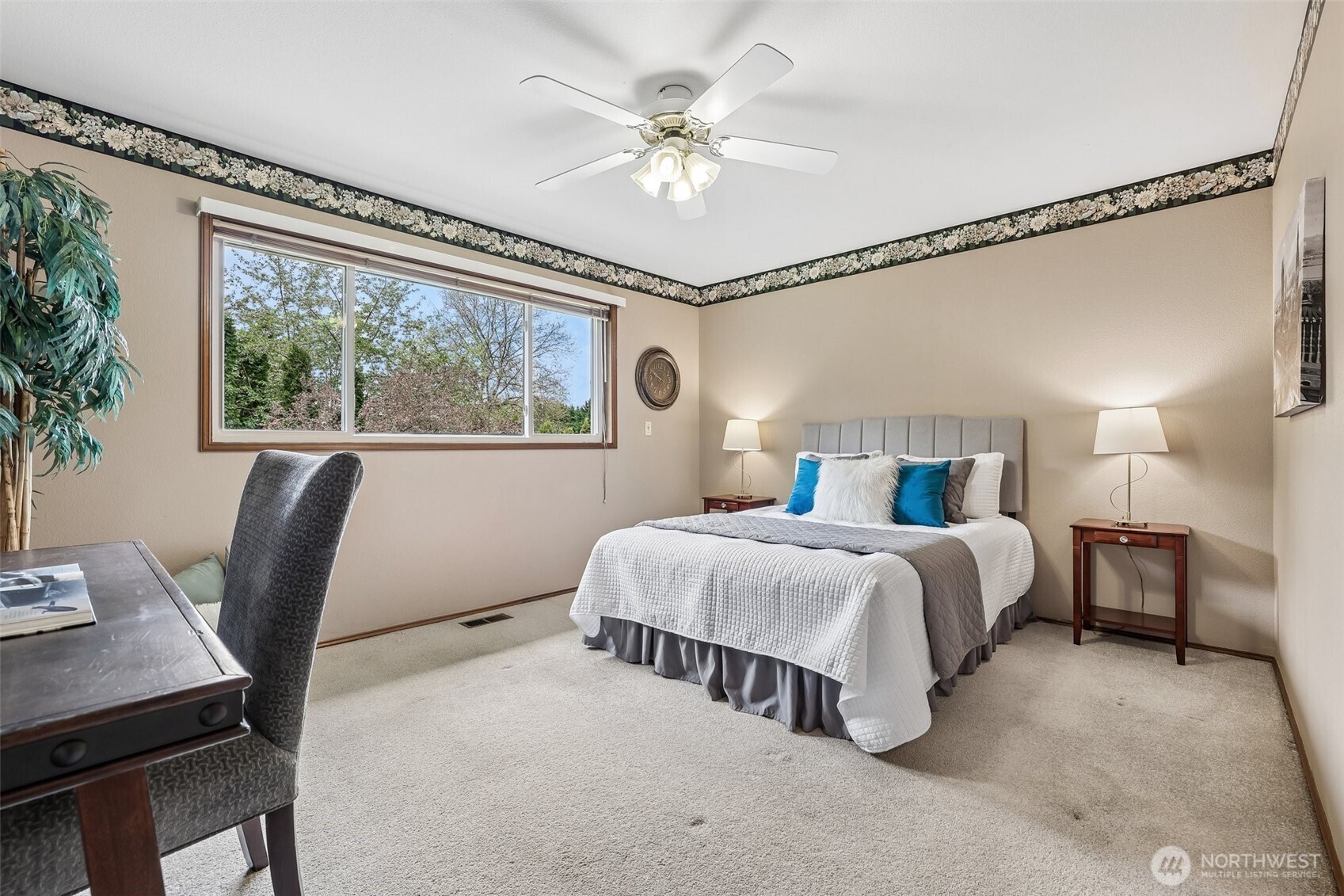 15601 160th Court Southeast Renton, WA 98058 - Photo 10 of 19 a bedroom with a large bed and a chandelier