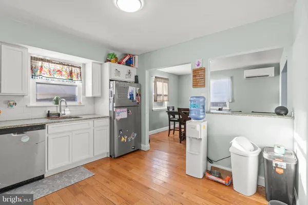 a kitchen with stainless steel appliances granite countertop a stove a sink dishwasher and a refrigerator