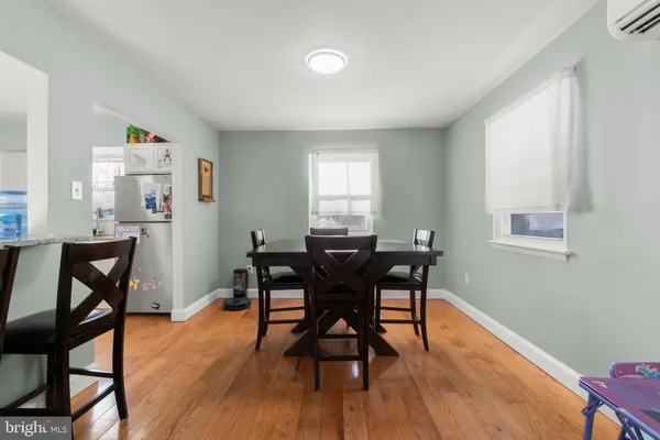 a dining room with furniture and wooden floor