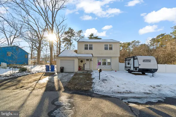 a view of a house with a yard covered in snow
