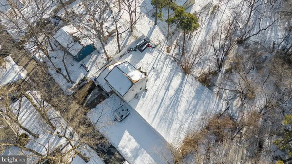 an aerial view of a house with a yard and wooden fence