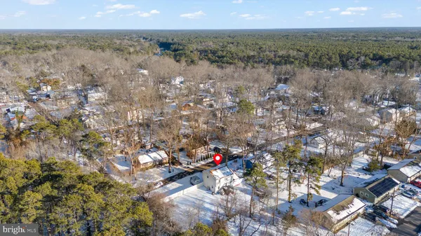 a view of a hallway with wooden floor and workspace