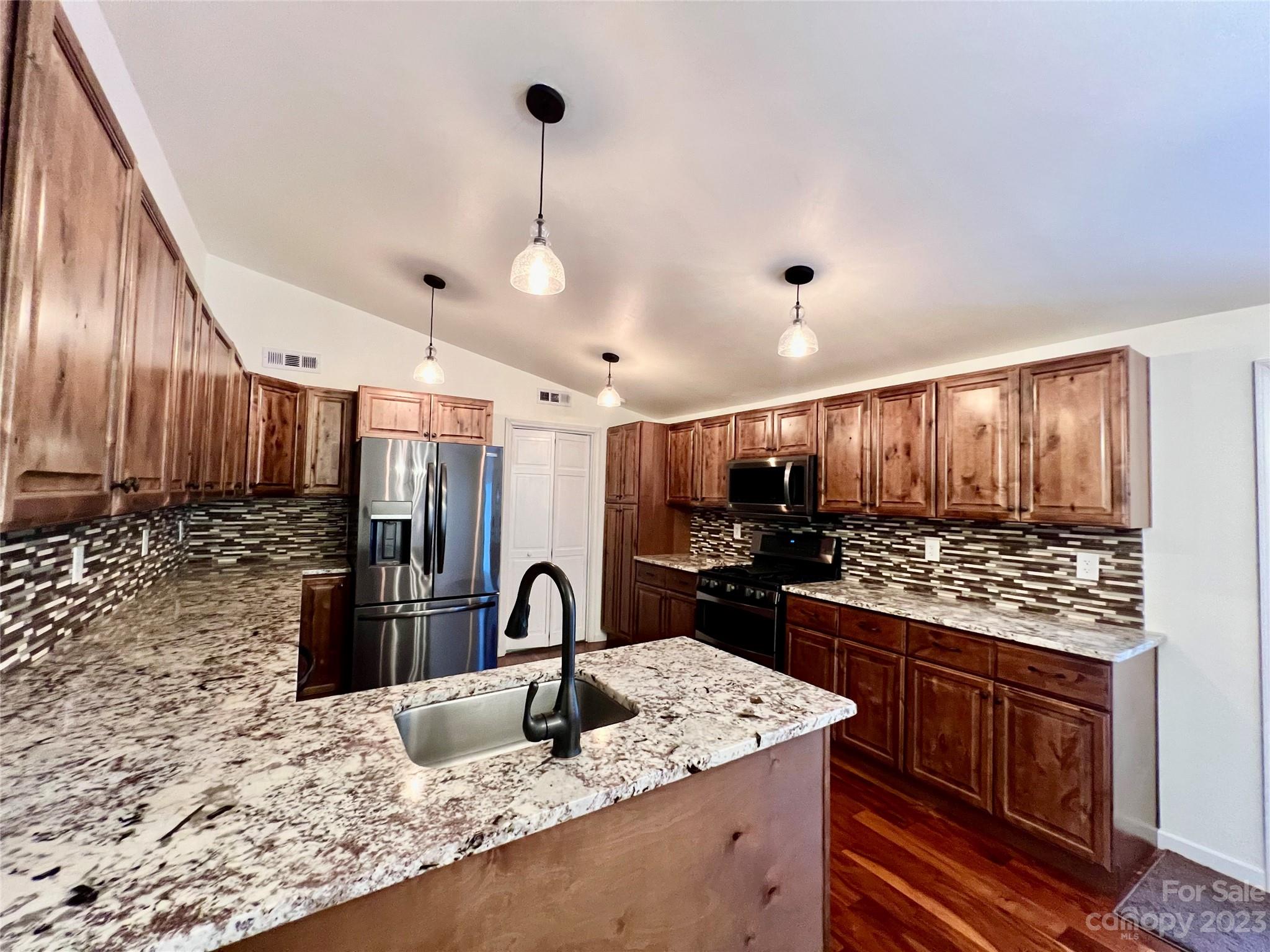 3413 Cedar Circle Road Lancaster, SC 29720 - Photo 12 of 45 a kitchen with stainless steel appliances granite countertop a sink stove and refrigerator
