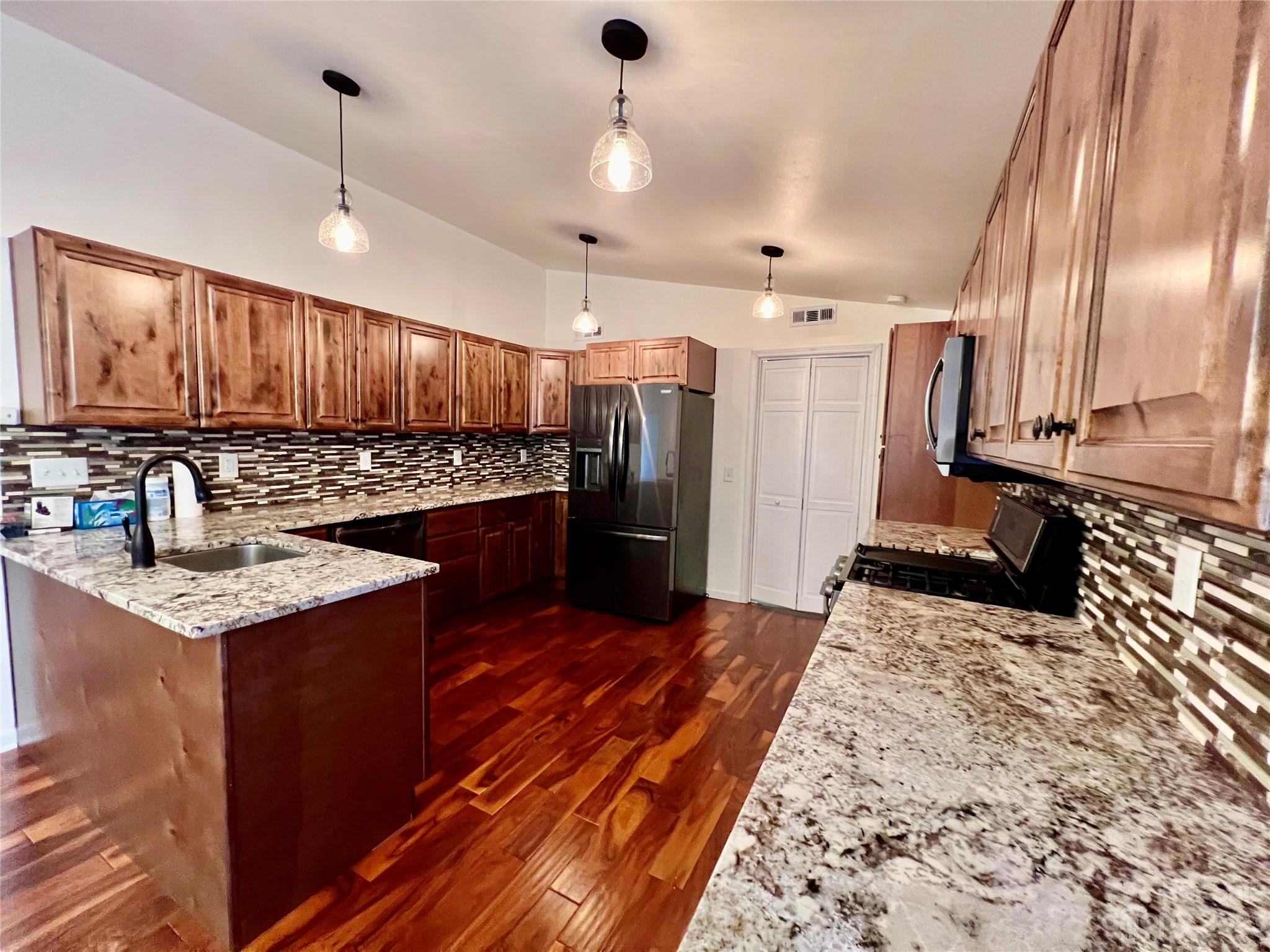 3413 Cedar Circle Road Lancaster, SC 29720 - Photo 13 of 45 a kitchen with stainless steel appliances granite countertop a sink stove and refrigerator