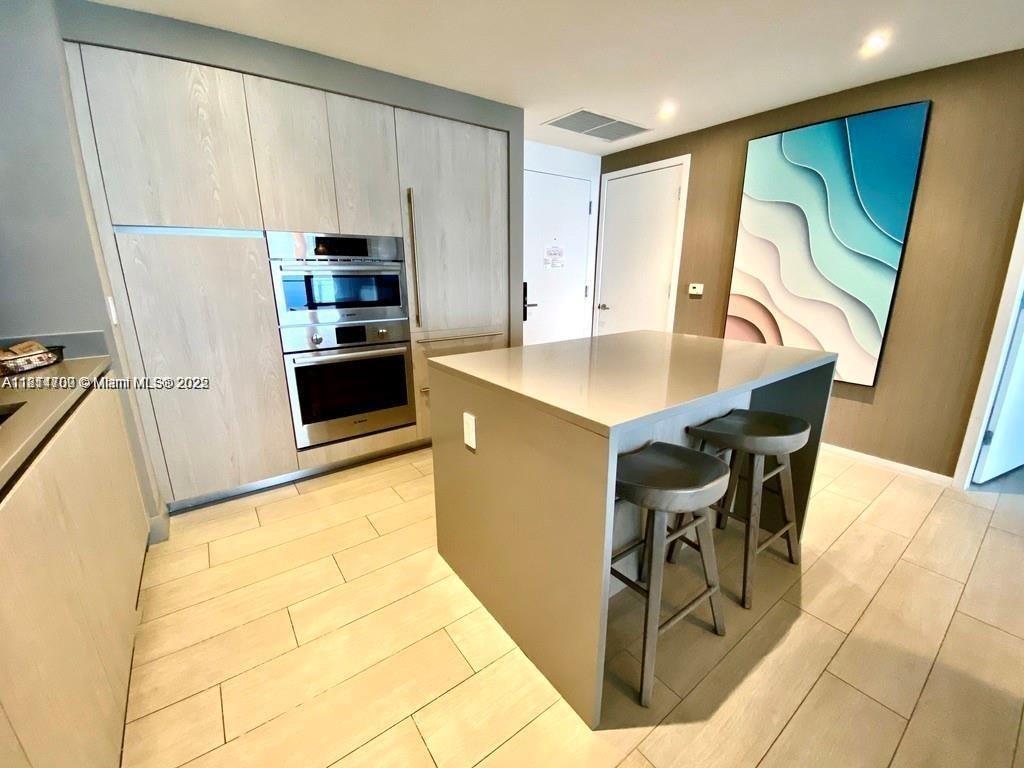 4010 South Ocean Drive, Unit R1905 Hollywood, FL 33019 - Photo 1 of 84 a kitchen with stainless steel appliances a stove a refrigerator a sink a counter top space and cabinets