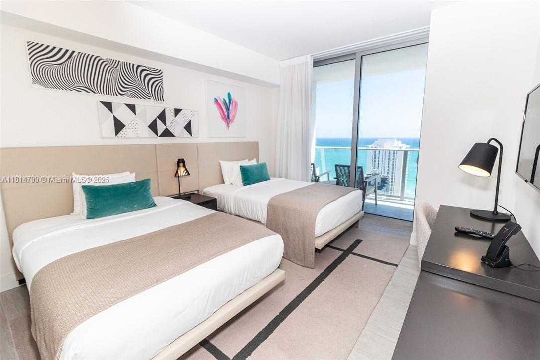 4010 South Ocean Drive, Unit R1905 Hollywood, FL 33019 - Photo 21 of 84 a bedroom with two beds and a large window