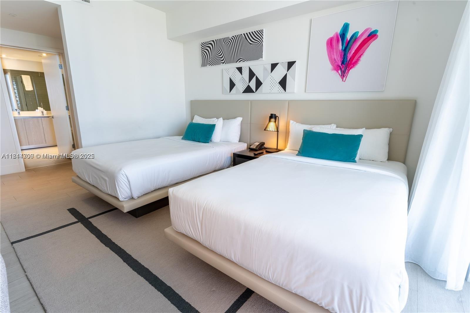 4010 South Ocean Drive, Unit R1905 Hollywood, FL 33019 - Photo 23 of 84 a bedroom with two beds and painting on the wall