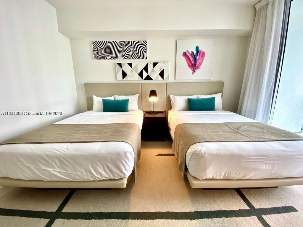 4010 South Ocean Drive, Unit R1905 Hollywood, FL 33019 - Photo 24 of 84 a bedroom with two beds and painting on the wall