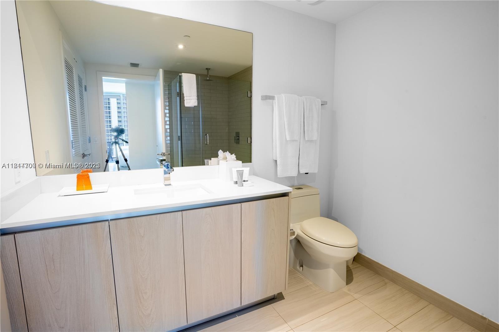 4010 South Ocean Drive, Unit R1905 Hollywood, FL 33019 - Photo 26 of 84 a bathroom with a sink toilet and a mirror