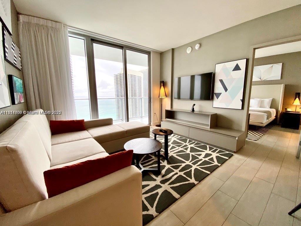 4010 South Ocean Drive, Unit R1905 Hollywood, FL 33019 - Photo 9 of 84 a living room with furniture and a large window