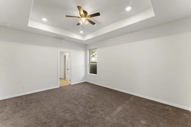 an empty room with a empty space and a ceiling fan