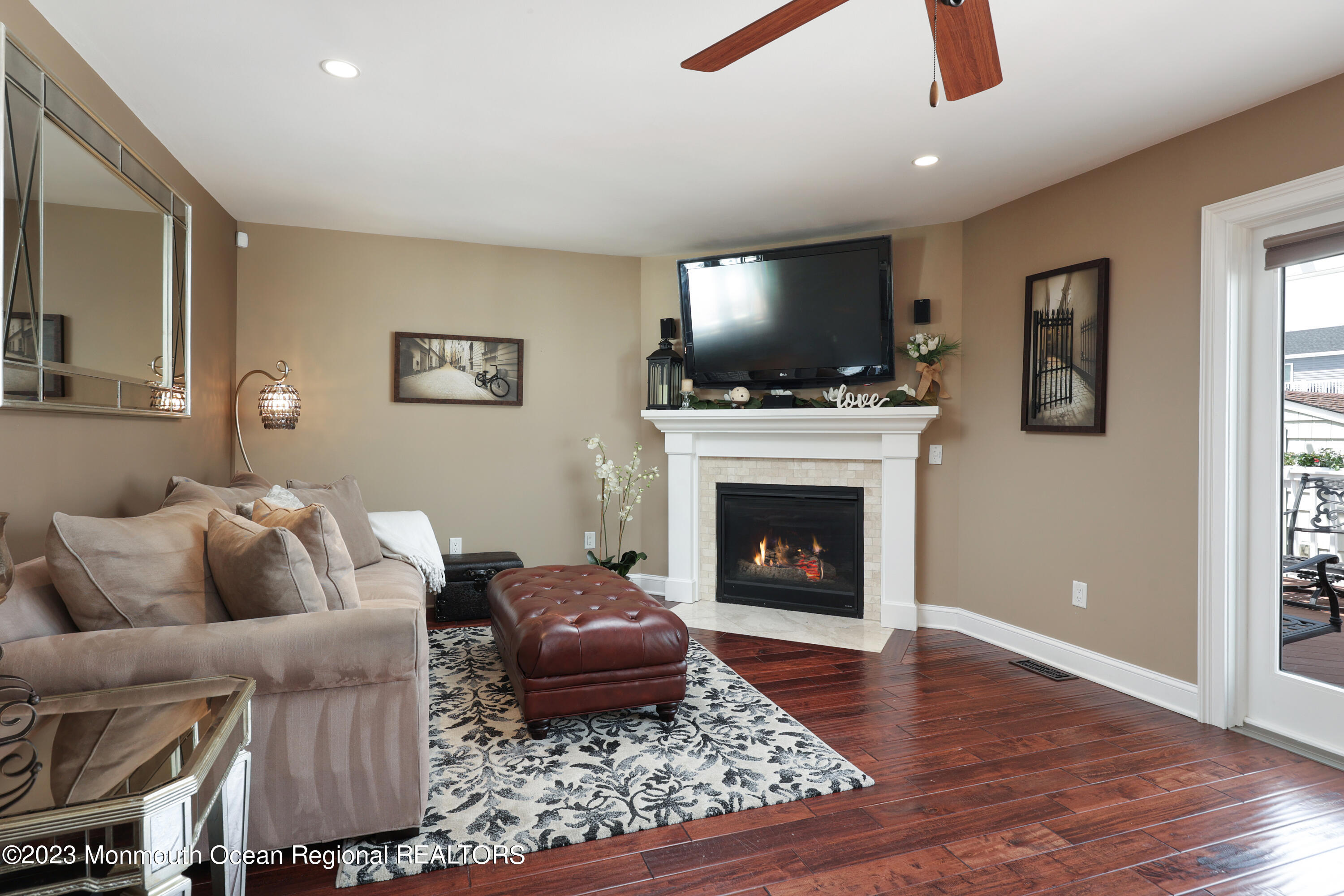 10 Halsey Drive Brick, NJ 08723 - Photo 15 of 46 a living room with furniture a flat screen tv and a fireplace