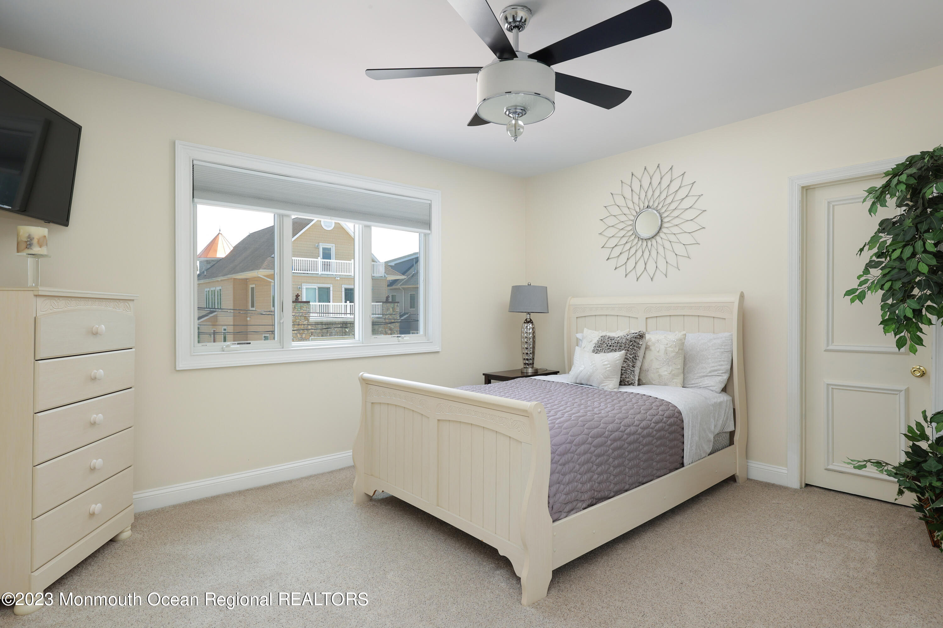 10 Halsey Drive Brick, NJ 08723 - Photo 22 of 46 a bedroom with a bed chandelier and a window