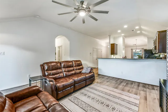 a living room with furniture and a chandelier