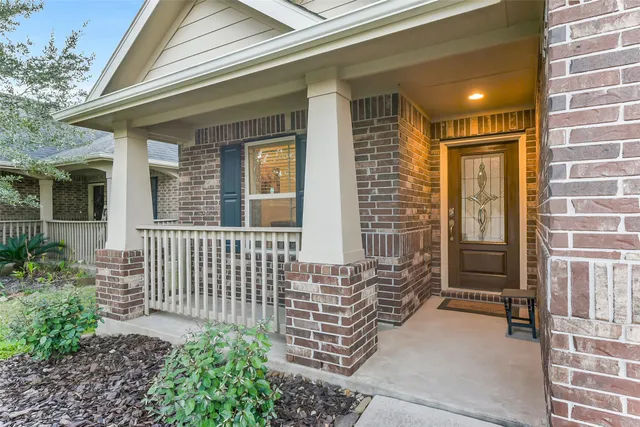 a view of a porch with a door and wooden floor