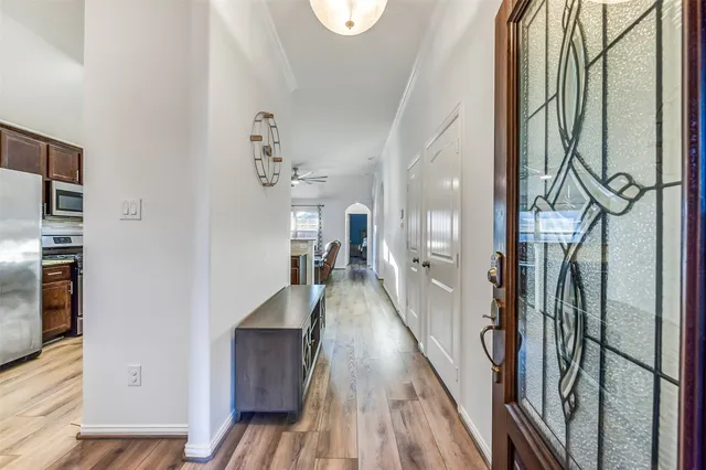 a view of a hallway with wooden floor and staircase