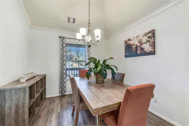 a dining room with furniture and wooden floor