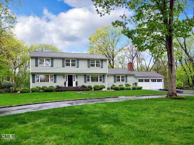 8 Pheasant Lane Westport, CT 06880 - Photo 1 of 1 a front view of a house with a garden and trees