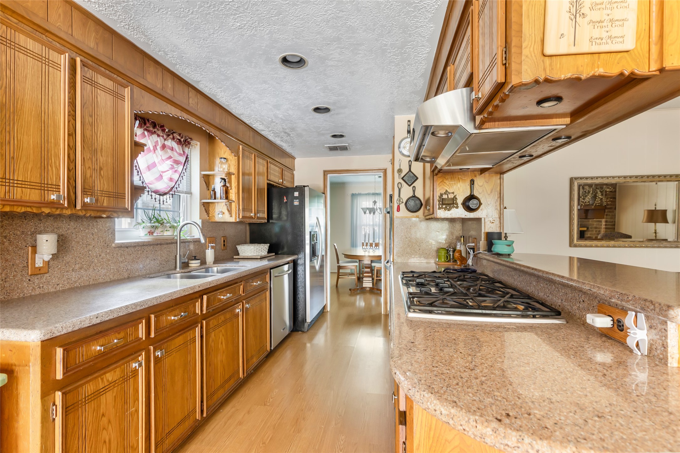 14510 Foxford Way Houston, TX 77015 - Photo 11 of 37 a kitchen with stainless steel appliances granite countertop a stove a sink dishwasher and cabinets with wooden floor