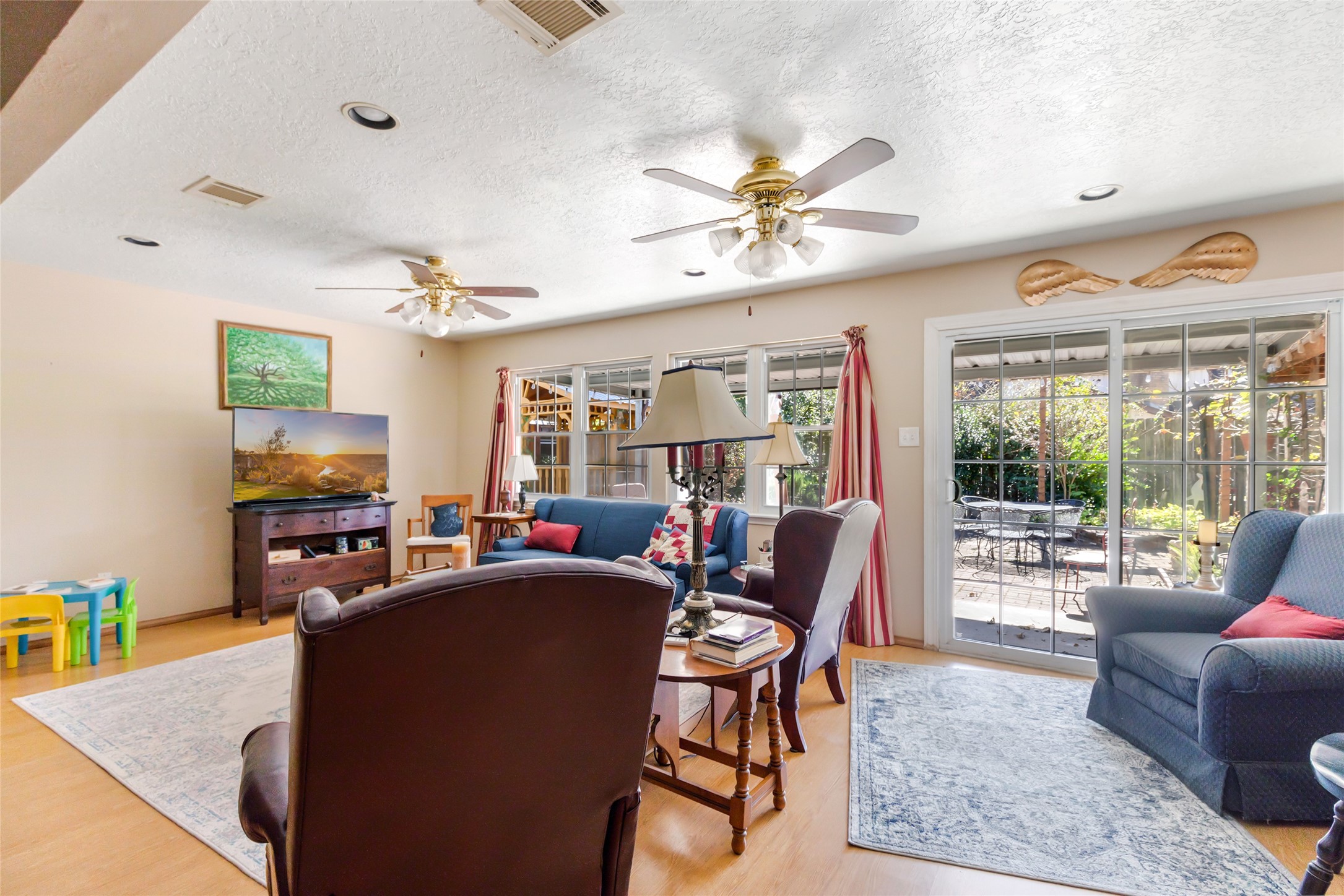 14510 Foxford Way Houston, TX 77015 - Photo 17 of 37 a living room with furniture a flat screen tv and a large window