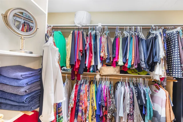 a view of walk in closet with clothes