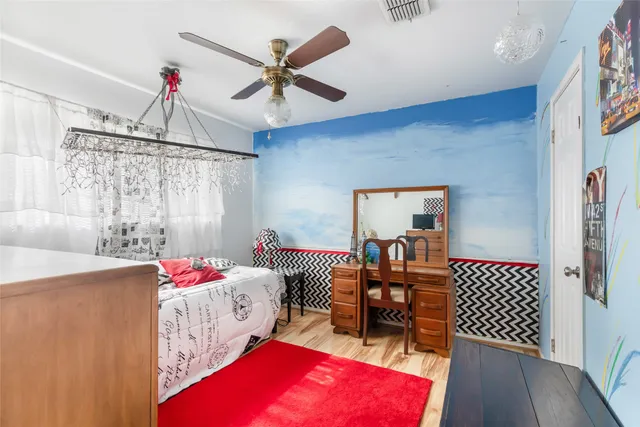 a bedroom with a bed and a chandelier