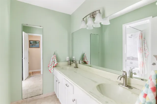 a bathroom with a sink vanity and a mirror