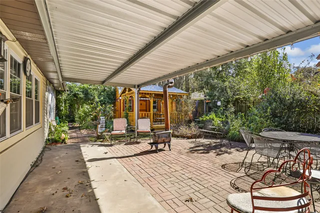 a building outdoor space with patio furniture and potted plants