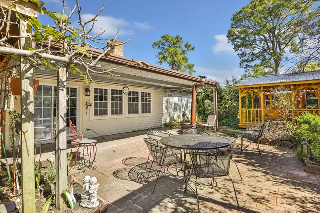 a view of a patio with table and chairs and potted plants