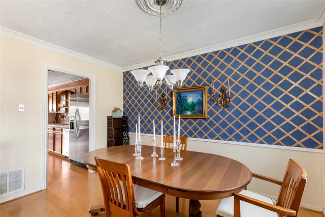 a dining room with furniture and wooden floor