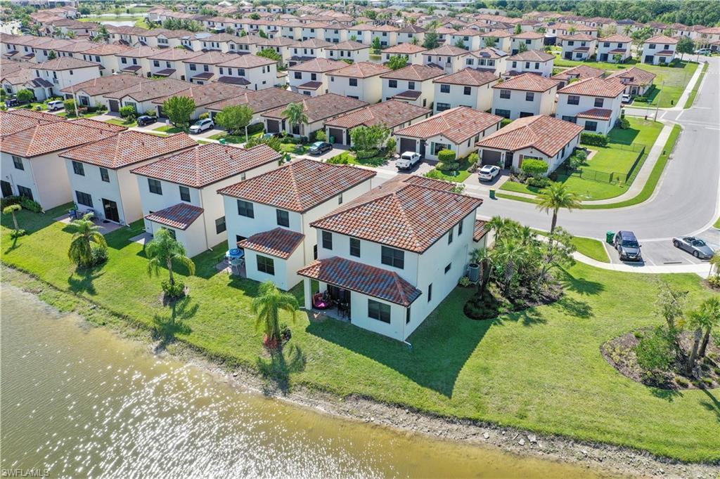 5595 Useppa Drive Ave Maria, FL 34142 - Photo 6 of 13 an aerial view of residential houses with yard