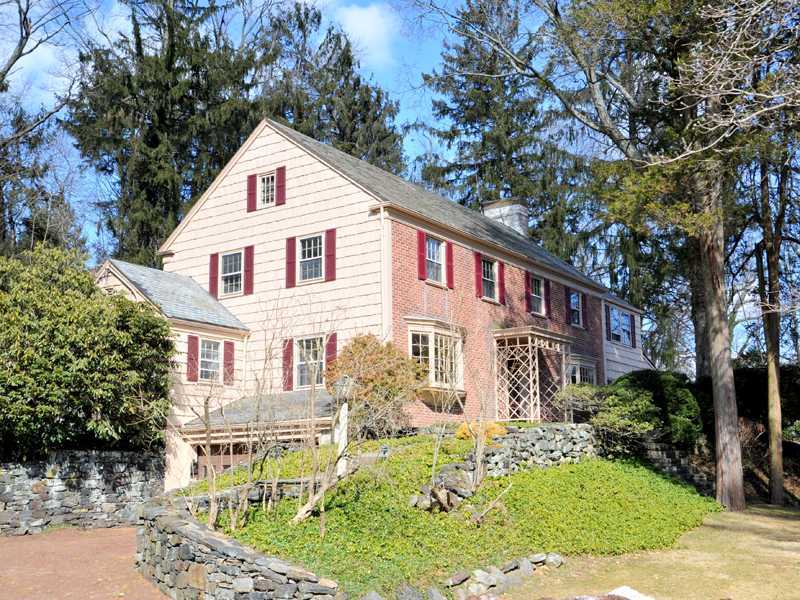 235 North Maple Avenue Greenwich, CT 06830 - Photo 1 of 19 a view of a white house with large windows and a small yard