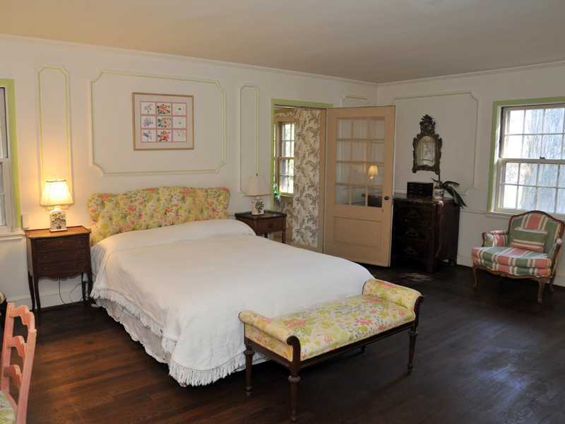 235 North Maple Avenue Greenwich, CT 06830 - Photo 13 of 19 a bedroom with a bed and wooden floor
