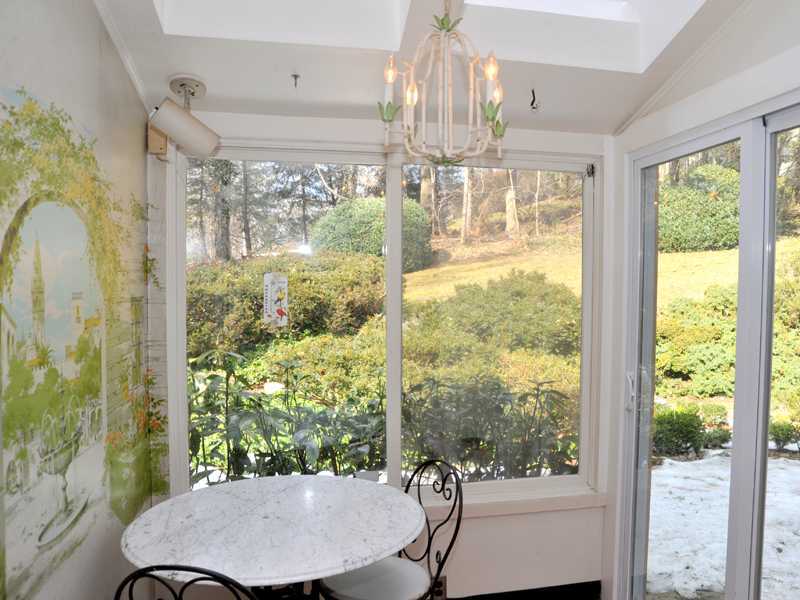 235 North Maple Avenue Greenwich, CT 06830 - Photo 9 of 19 a view of a dining room with furniture a chandelier and large windows