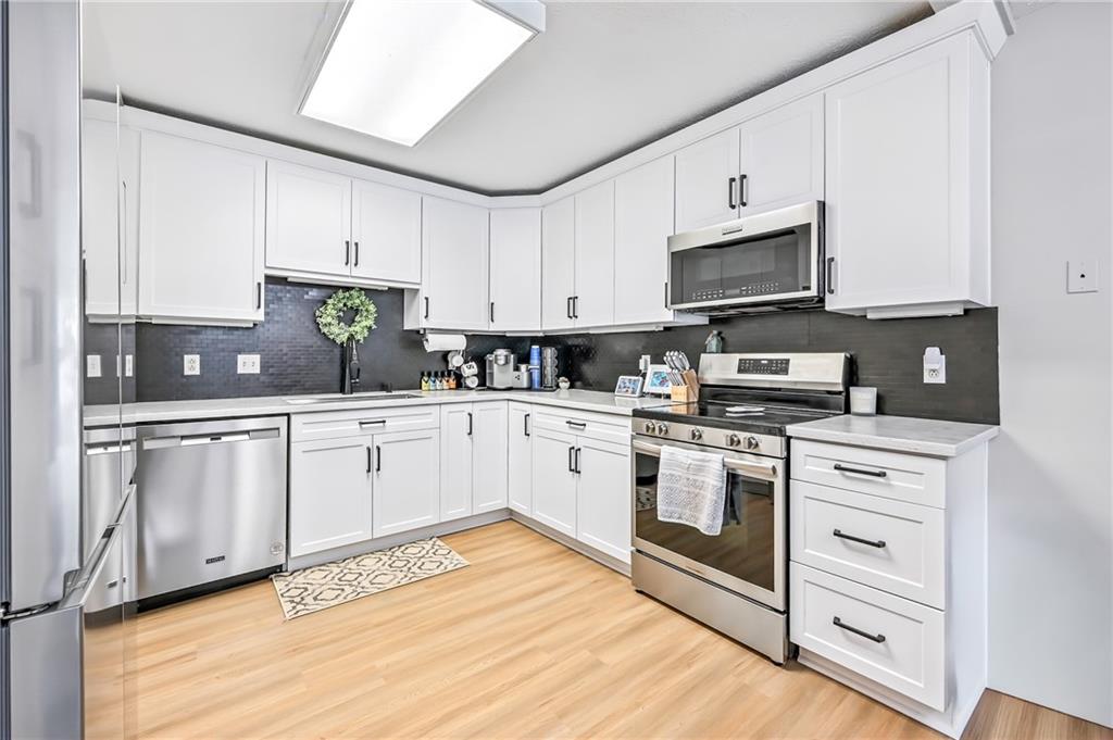 723 Rollinson Road Hermitage, PA 16148 - Photo 13 of 38 a kitchen with stainless steel appliances granite countertop a sink a stove a refrigerator and cabinets