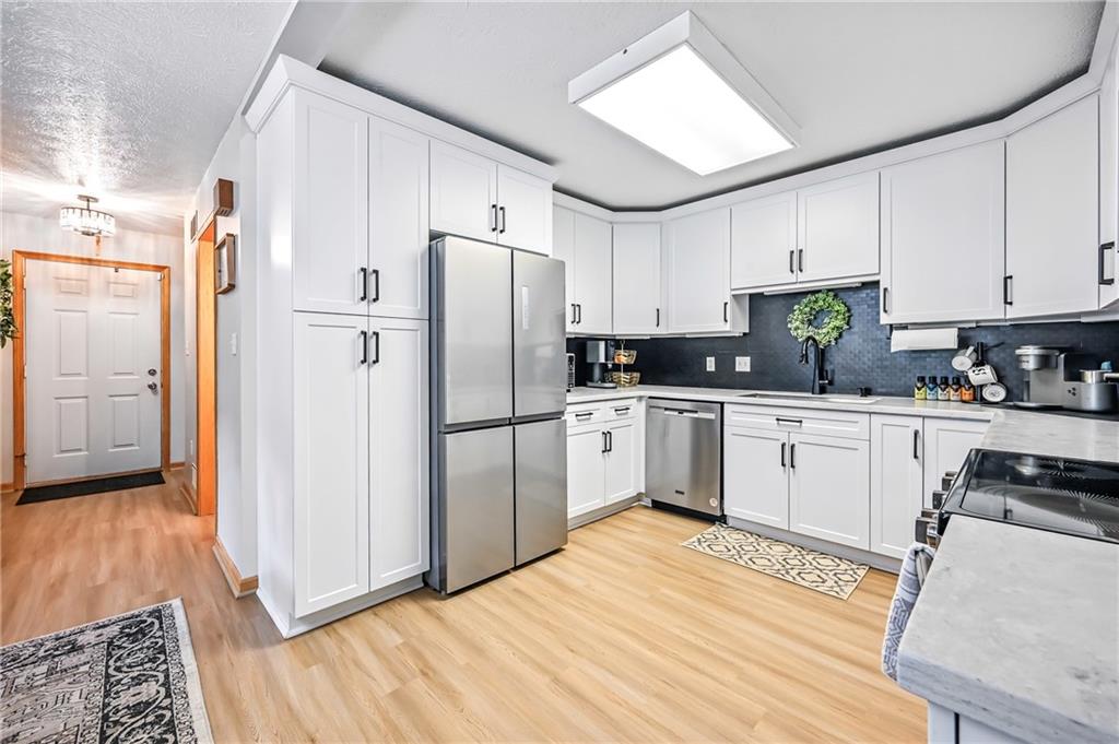 723 Rollinson Road Hermitage, PA 16148 - Photo 14 of 38 a kitchen with white cabinets and white appliances