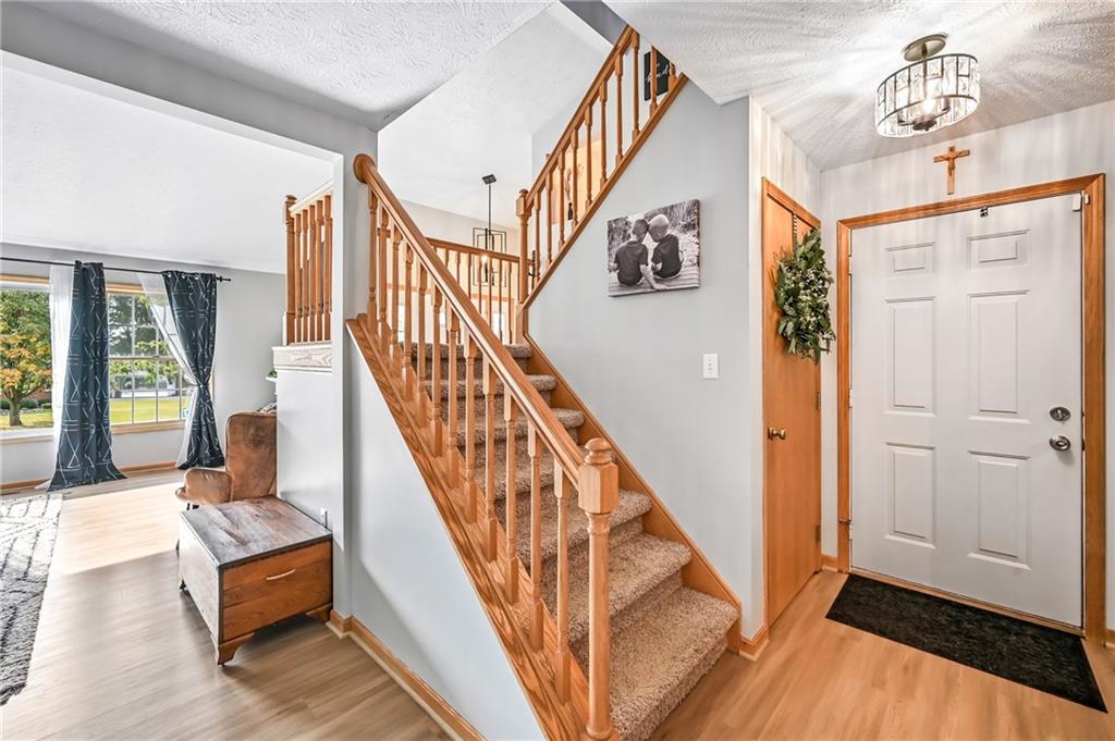 723 Rollinson Road Hermitage, PA 16148 - Photo 17 of 38 a view of staircase with furniture and a window