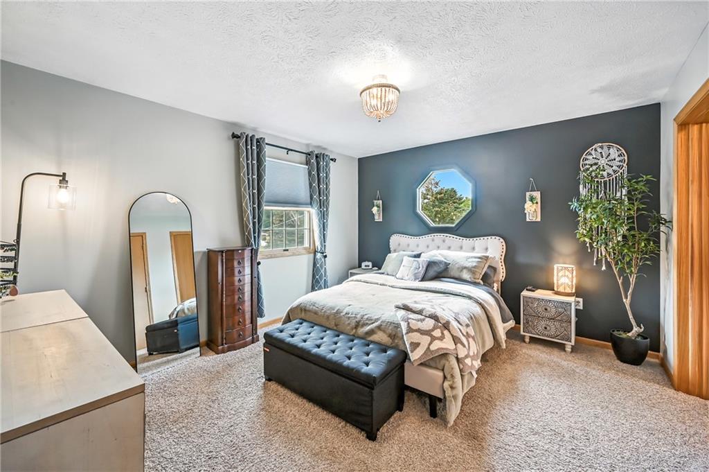 723 Rollinson Road Hermitage, PA 16148 - Photo 28 of 38 a bedroom with a bed and a chandelier