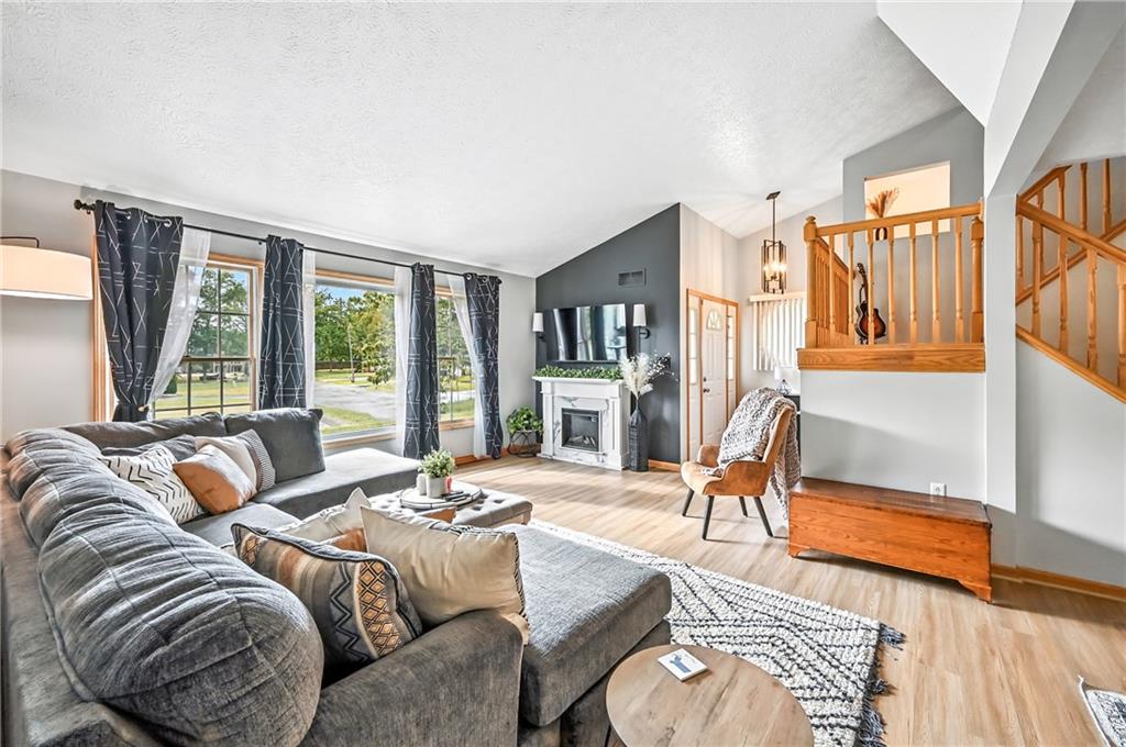 723 Rollinson Road Hermitage, PA 16148 - Photo 8 of 38 a living room with furniture fireplace and a large window