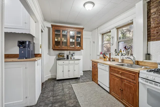 a kitchen with sink cabinets and window
