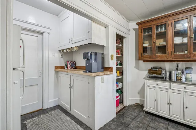a kitchen with cabinets appliances and a window
