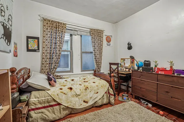 a bedroom with furniture and a wooden floor