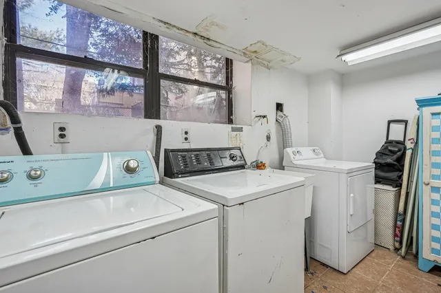 a backyard of a house with barbeque oven and outdoor seating